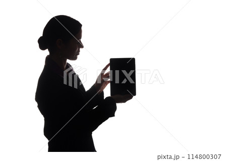 Young woman in suit shows pointer forward, side view - silhouette 114800307