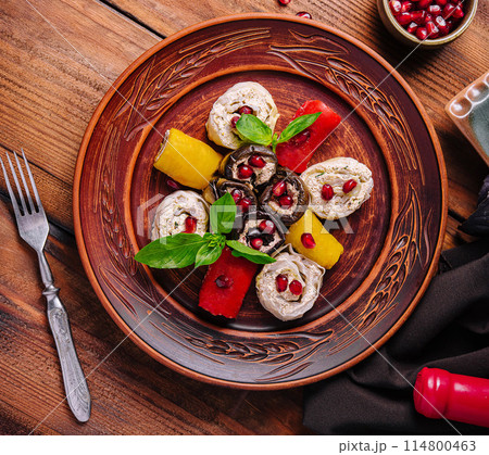 Gourmet stuffed chicken with pomegranate and basil on wooden table Gourmet stuffed chicken with pomegranate and basil on wooden table 114800463