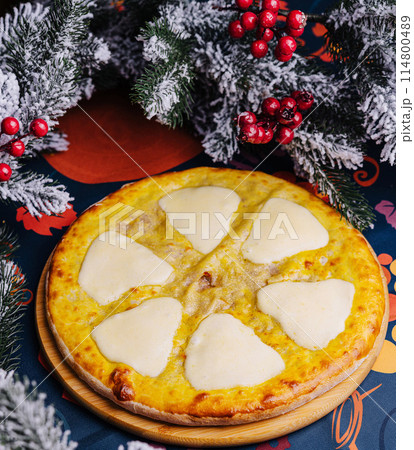 Festive cheese pizza under christmas tree Festive cheese pizza under christmas tree 114800489
