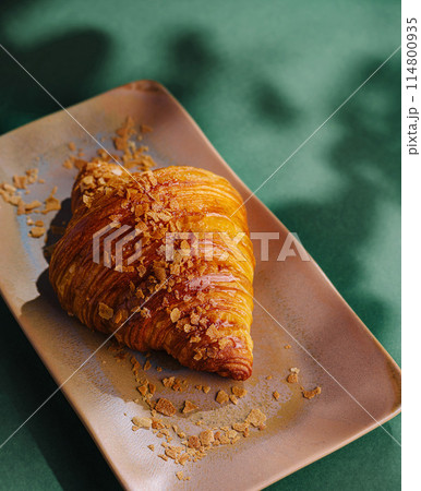 Gourmet croissant on ceramic plate 114800935