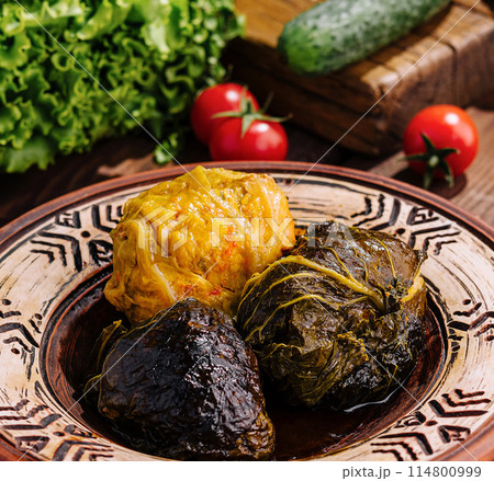 Traditional stuffed grape leaves on ceramic plate 114800999