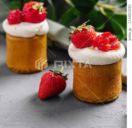Fresh strawberry tarts on grey backdrop Fresh strawberry tarts on grey backdrop 114801092