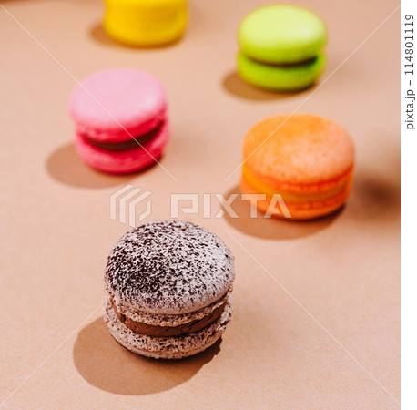 Colorful macarons on a warm beige background Colorful macarons on a warm beige background 114801119