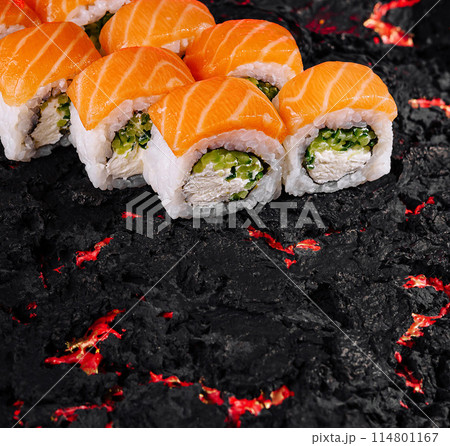 Sushi roll on textured black surface Sushi roll on textured black surface 114801167