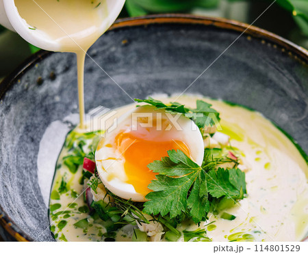 Gourmet poached egg breakfast bowl with hollandaise sauce Gourmet poached egg breakfast bowl with hollandaise sauce 114801529