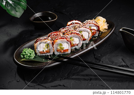 Delectable sushi roll platter on dark background 114801770