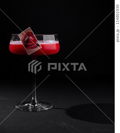 Elegant cocktail with artistic garnish on black background 114801930