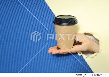 Craft cup for coffee in hand on a light background Craft cup for coffee in hand on a light background 114802467