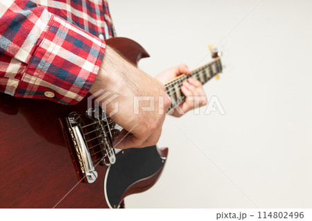 A man plays a beautiful guitar close-up 114802496