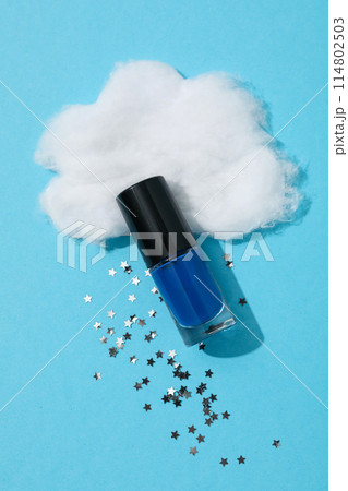 Blue nail polish with decorative paper clouds 114802503