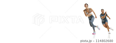 Banner. Man and woman running in motion, showcasing their speed and agility against white studio background with copy space. 114802680