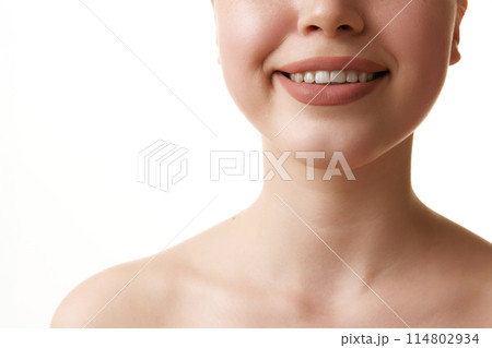 Close up of beautiful wide female smile against white studio background. Oral care dentistry, stomatology. Close up of beautiful wide female smile against white studio background. Oral care dentistry, stomatology. 114802934