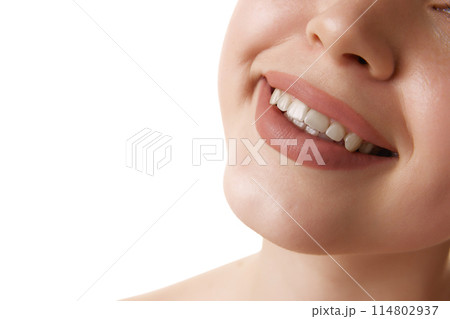 Close up of beautiful wide female smile against white studio background. Oral care dentistry, stomatology. 114802937