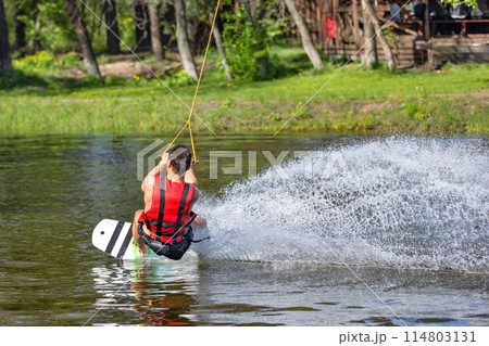 Sportsman water skiing on lake, extreme summer water sport. 114803131