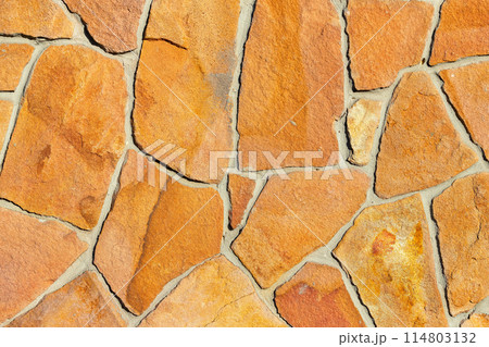 Texture of golden sandstone bricks in rough masonry wall. 114803132