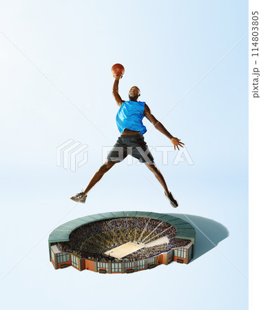 African-American man, basketball player in mid-air pose with ball over stadium, playing. Focused champion. Creative collage. 3D render. African-American man, basketball player in mid-air pose with ball over stadium, playing. Focused champion. Creative collage. 3D render. 114803805