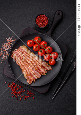 Delicious bacon in the form of slices with salt, spices and herbs Delicious bacon in the form of slices with salt, spices and herbs 114804934