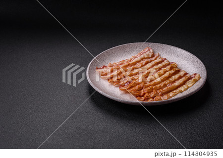 Delicious bacon in the form of slices with salt, spices and herbs Delicious bacon in the form of slices with salt, spices and herbs 114804935