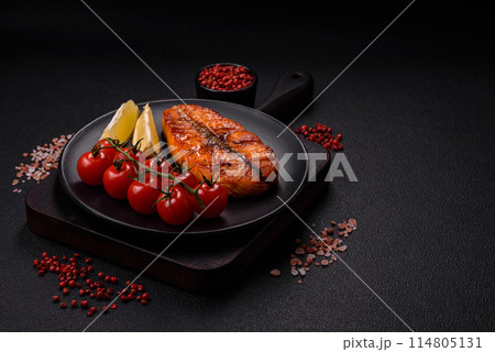 Fresh cooked delicious salmon steak with spices and herbs 114805131