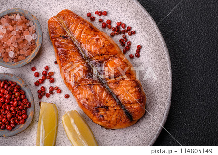 Fresh cooked delicious salmon steak with spices and herbs 114805149