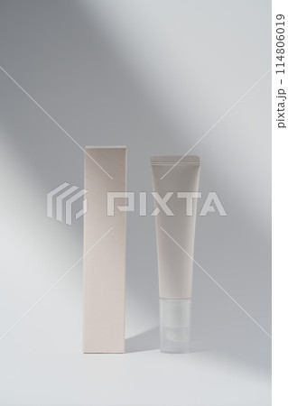 Mockup cream tube and box in shadow on blank background. Modern cosmetic presentation 114806019