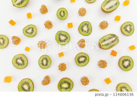 Candied fruit jelly with kiwi fruits on white. Flat lay, top view. Candied fruit jelly with kiwi fruits on white. Flat lay, top view. 114806136