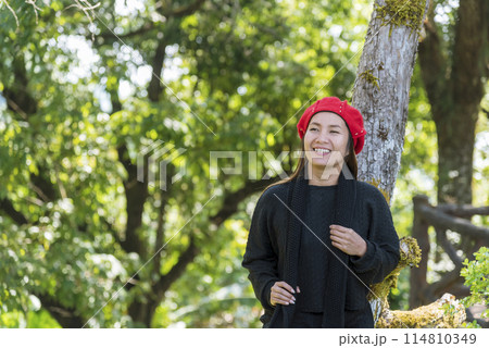 Portrait Asian Woman relaxing in green park. Happy Relax asian woman smiling face at outdoors garden. Young women enjoy nature freedom lifestyle. Greenery wellbeing outside beauty in nature. 114810349