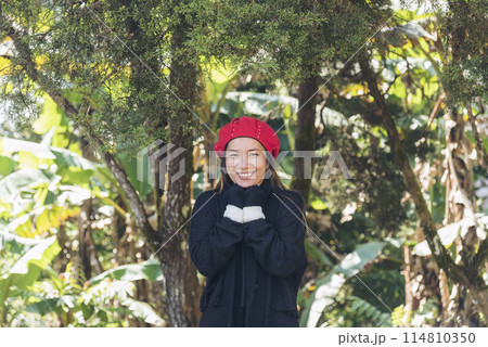 Portrait Asian Woman relaxing in green park. Happy Relax asian woman smiling face at outdoors garden. Young women enjoy nature freedom lifestyle. Greenery wellbeing outside beauty in nature. 114810350