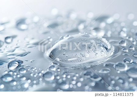 A close up of a drop of water resting on a surface A close up of a drop of water resting on a surface 114811375