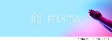 Two kids hands clapping against multicolored background in neon light. Success, positivity, celebration. 114812321