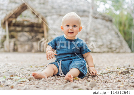Baby tourist at Coba, Mexico. Ancient mayan city in Mexico. Coba is an archaeological area and a famous landmark of Yucatan Peninsula. Cloudy sky over a pyramid in Mexico 114812645