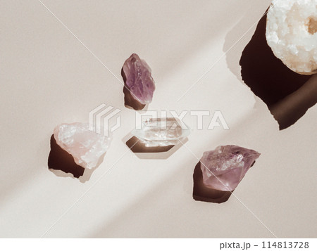 Collection of crystals quartz and amethyst on a beige background with shadows from sunlight 114813728