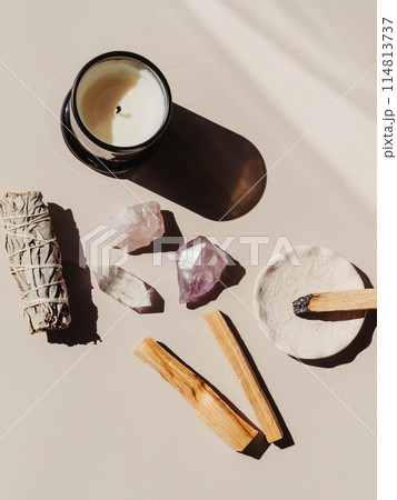 White sage and Palo Santo and amethyst and quartz crystals on a light beige background 114813737