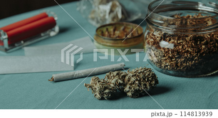 cannabis bud and grinder on a table, banner format cannabis bud and grinder on a table, banner format 114813939