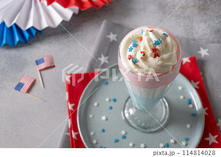 Patriotic homemade milkshake on gray background. Food and dessert for Independence Day in red, white and blue colors. Copy space. Close up. 114814028
