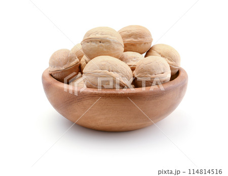 Walnuts in a wooden bowl isolated. Walnuts in a wooden bowl isolated. 114814516