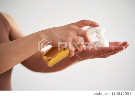 Hands hold a savory facial foam demonstrating its texture. Hands hold a savory facial foam demonstrating its texture. 114815597