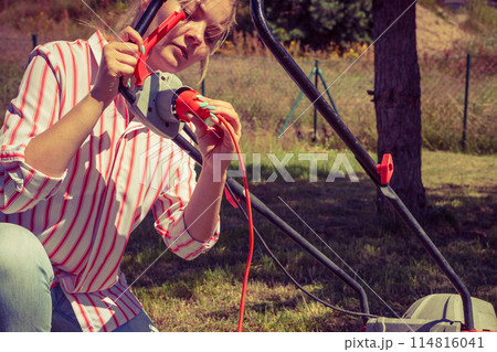 Woman mowing green grass 114816041