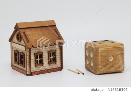 Homemade dice and matches next to a toy house, the concept of uncertainty, security and insurance, 114816505