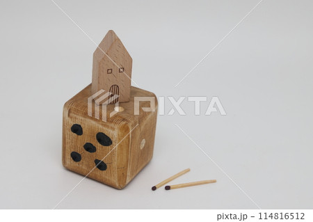 Homemade dice and matches next to a toy house, the concept of uncertainty, security and insurance, Homemade dice and matches next to a toy house, the concept of uncertainty, security and insurance, 114816512