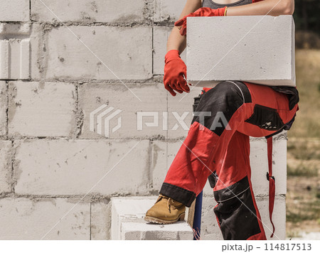 Woman working with bricks 114817513