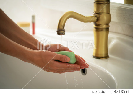 Woman is washing her hands. 114818551