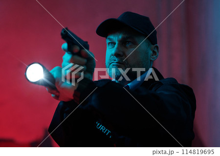 Security guard with flashlight and gun Security guard with flashlight and gun 114819695