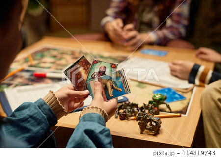 Hands of girl choosing board game card 114819743