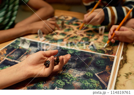 Hand of child holding group of dice 114819761