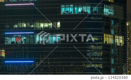 Windows in modern city office building at night timelapse. 114820380