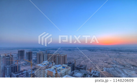 Cityscape of Ajman from rooftop during sunrise timelapse. United Arab Emirates. 114820609