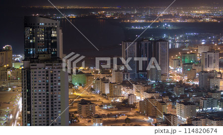 Cityscape of Ajman from rooftop night aerial timelapse 114820674