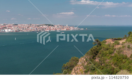Panorama of Lisbon historical centre aerial timelapse viewed from above the southern margin of the Tagus or Tejo River. 114820750
