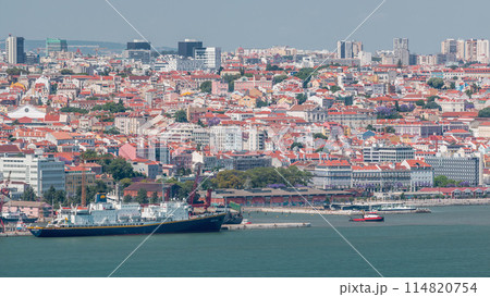 Panorama of Lisbon historical centre aerial timelapse viewed from above the southern margin of the Tagus or Tejo River. 114820754